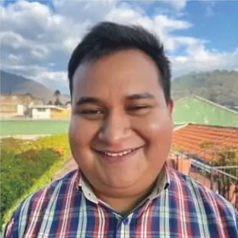 Person stands on grassy hilltop