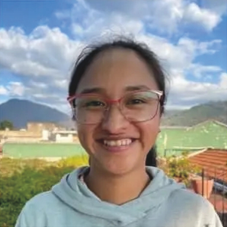 Person wears glasses on cloudy hill