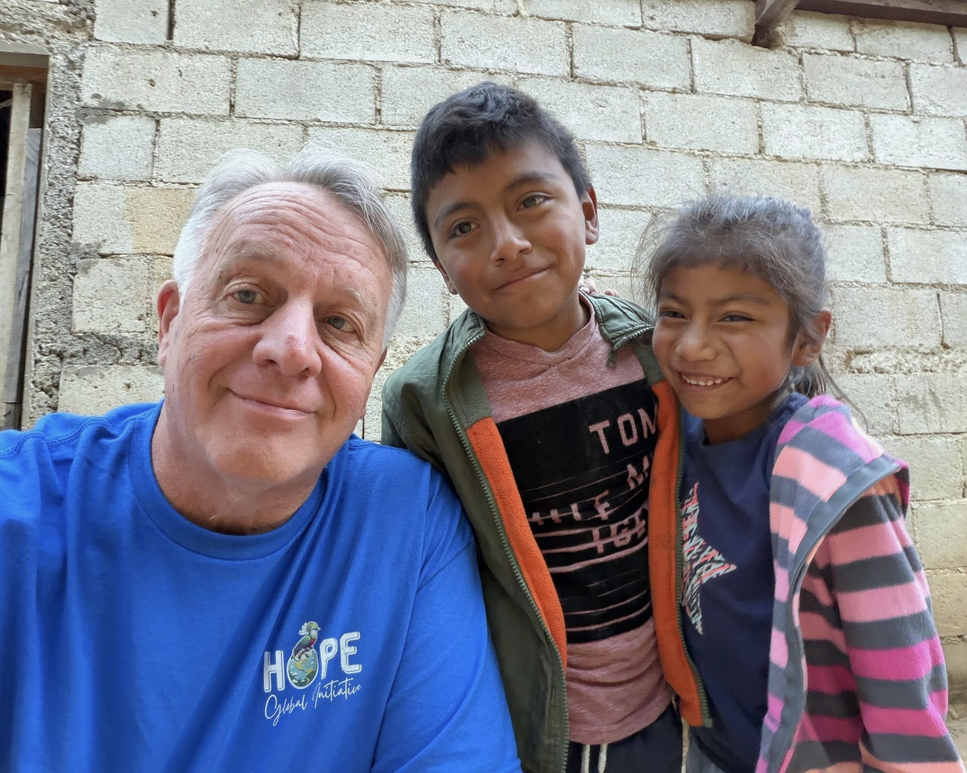 Children wearing clothing in a brick building