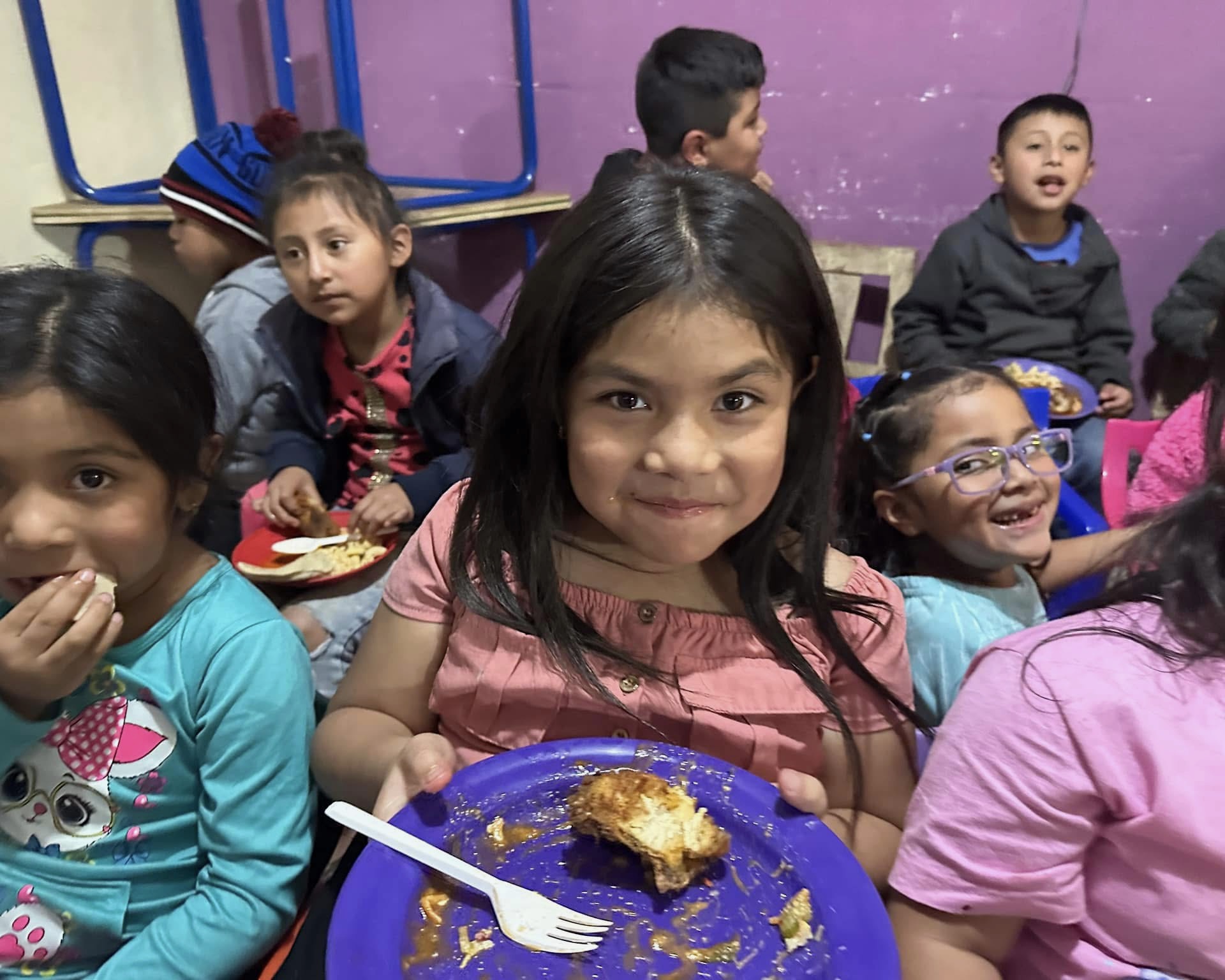 Child wearing jacket sitting at table