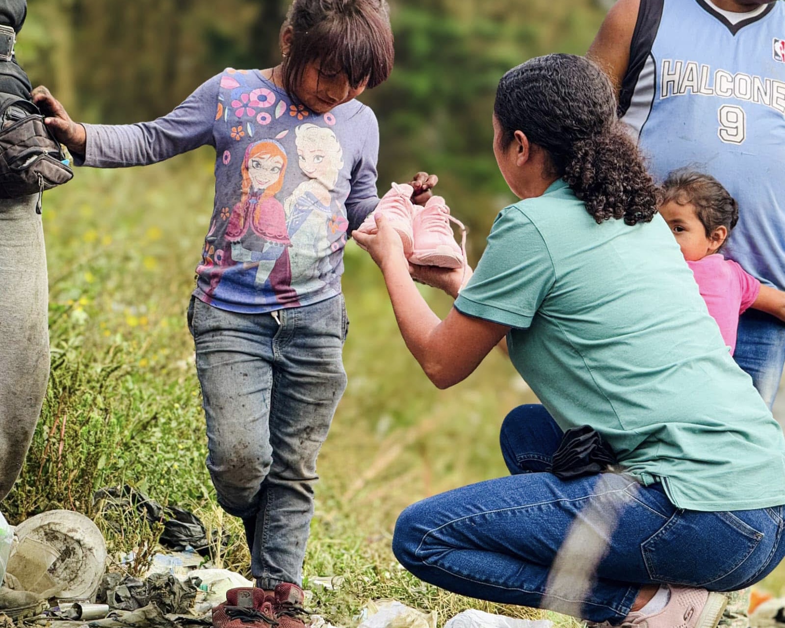 Child wearing jeans and shoes on grassy land