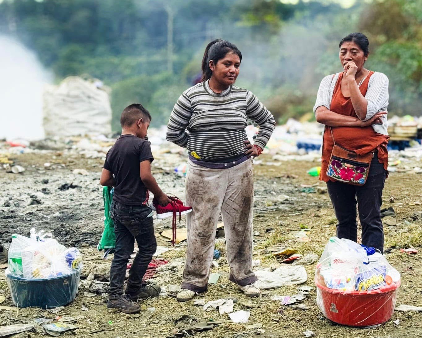 People with luggage near rocks
